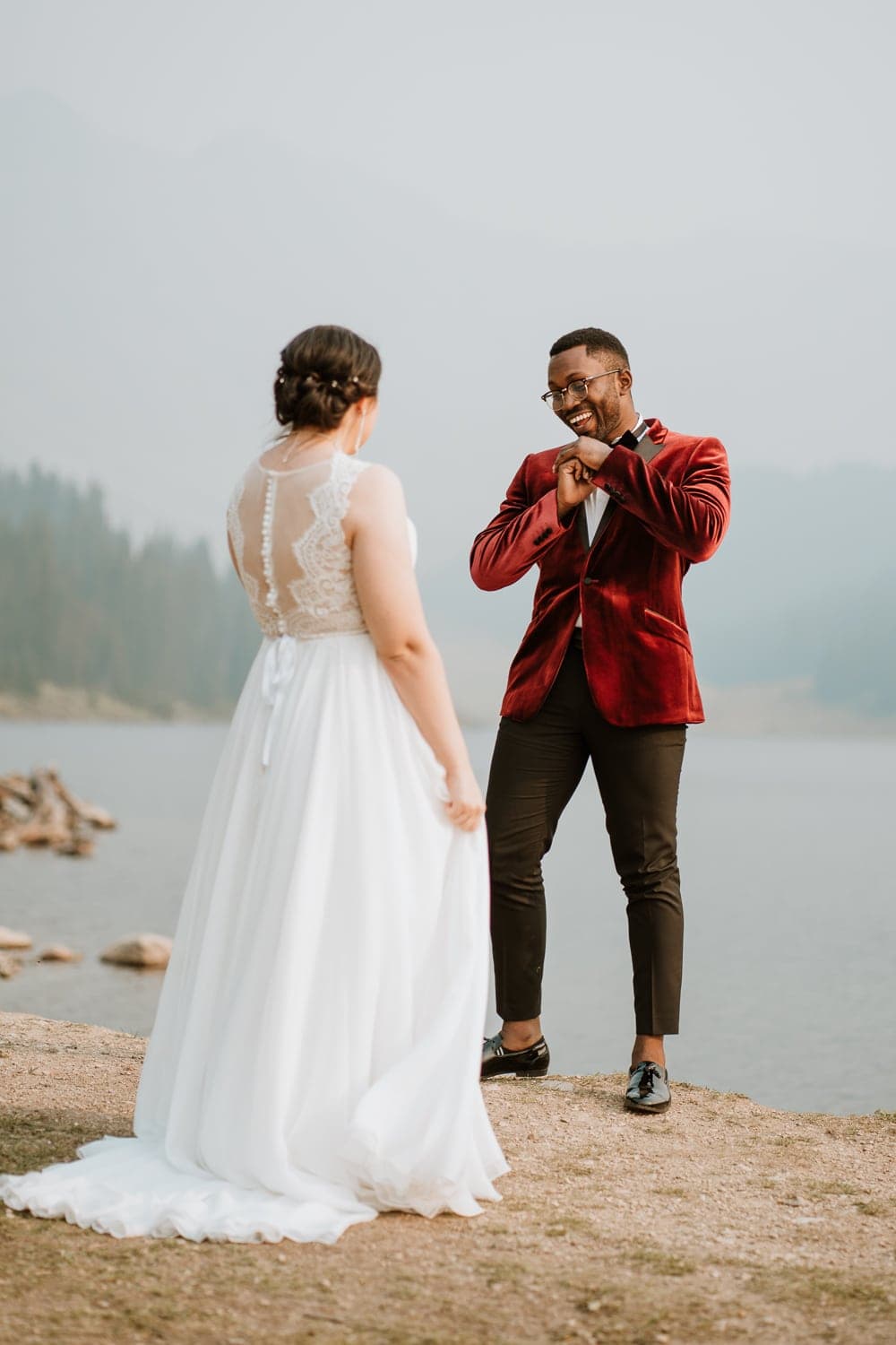 https://www.paigeweberphotography.com/wp-content/uploads/2020/01/how-to-plan-an-elopement-groom-dances-during-first-look-2.jpeg
